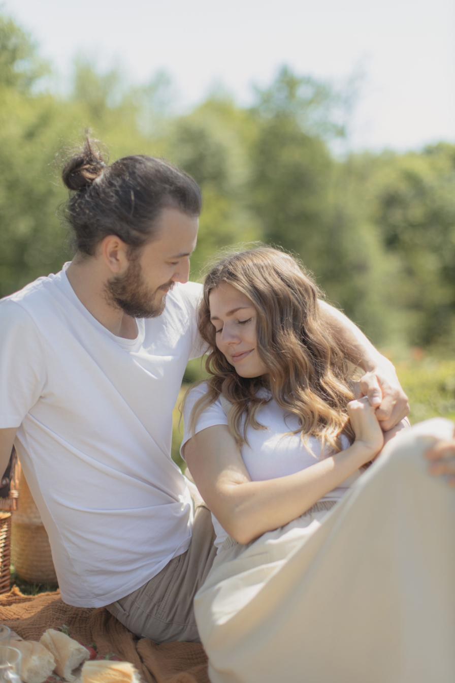 Karim and Nour sharing a quiet moment at a countryside picnic.